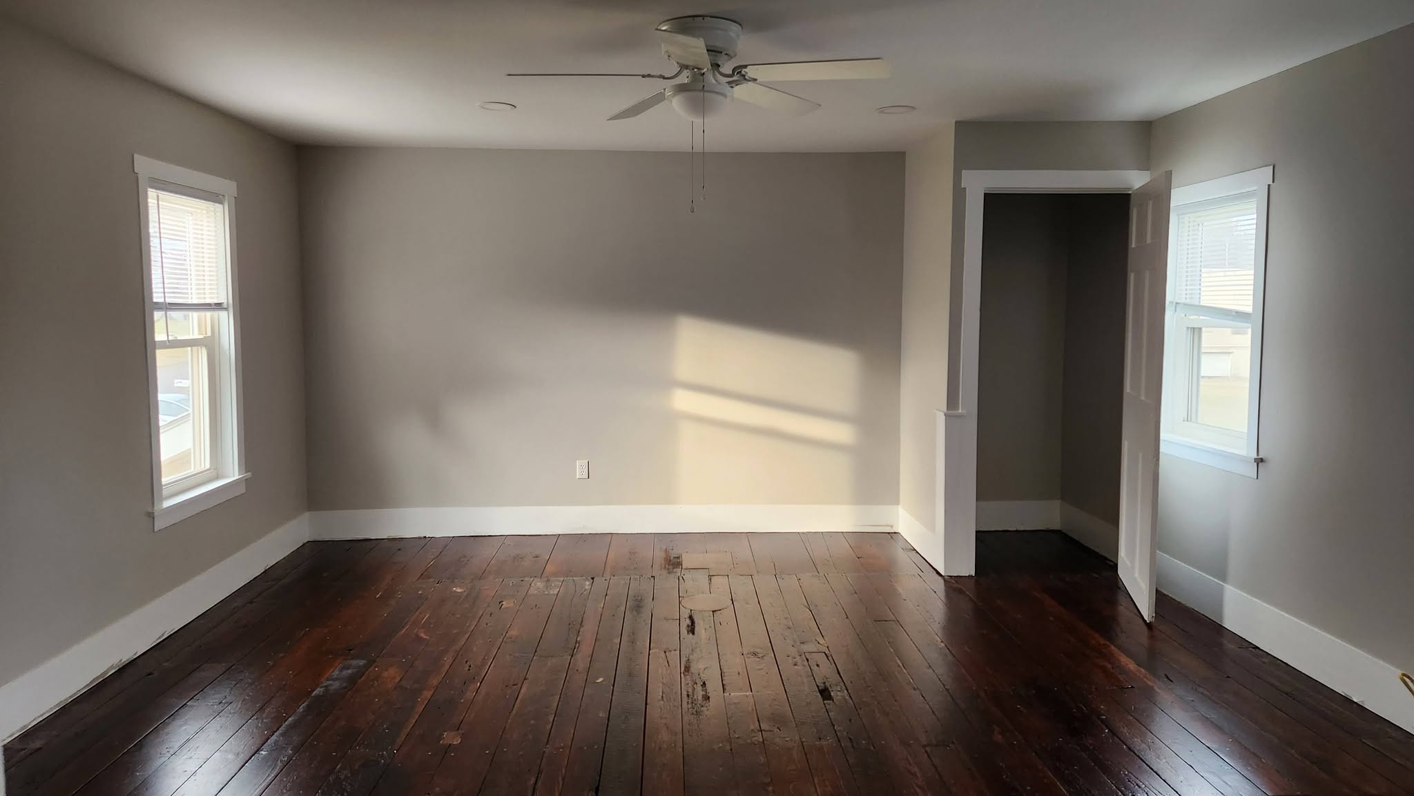 Original hardwood floors with sunlight through the window